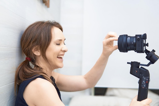 Portrait of smiling young woman holding camera