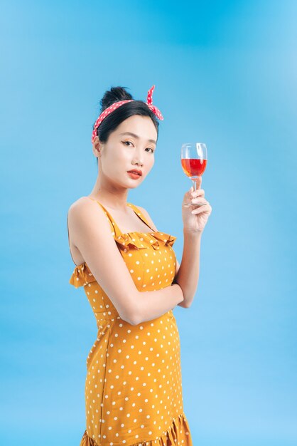 Portrait of a smiling young woman holding a glass of red wine