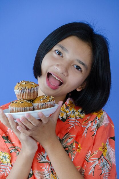 Portrait of a smiling young woman holding ice cream