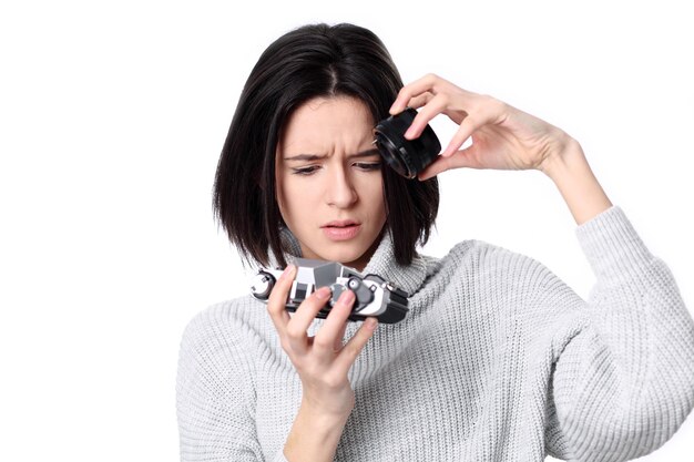 Portrait of a smiling young woman holding retro camera