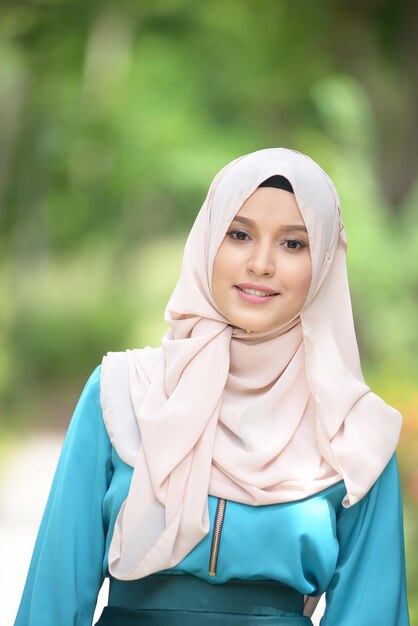 Photo portrait of smiling young woman in park