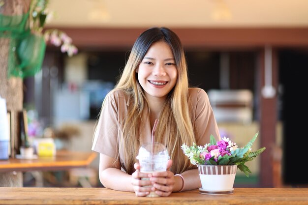 Portrait of a smiling young woman in restaurant