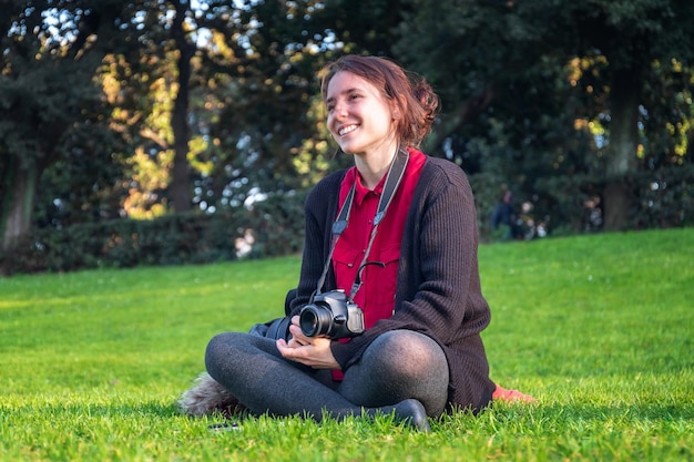 Portrait of smiling young woman sitting on grass