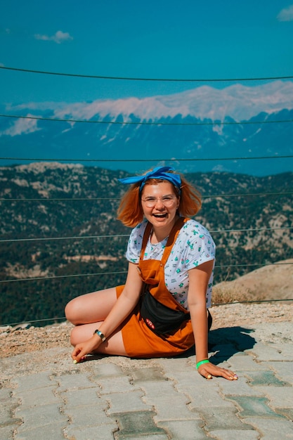 Portrait of smiling young woman sitting on land