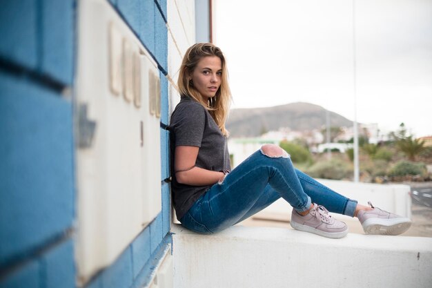 Portrait of smiling young woman sitting outdoors