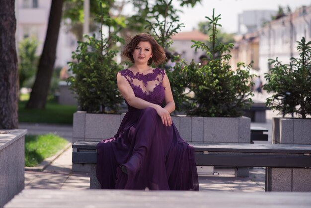 Portrait of a smiling young woman sitting outdoors