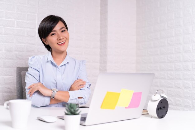 Portrait of a smiling young woman sitting on table