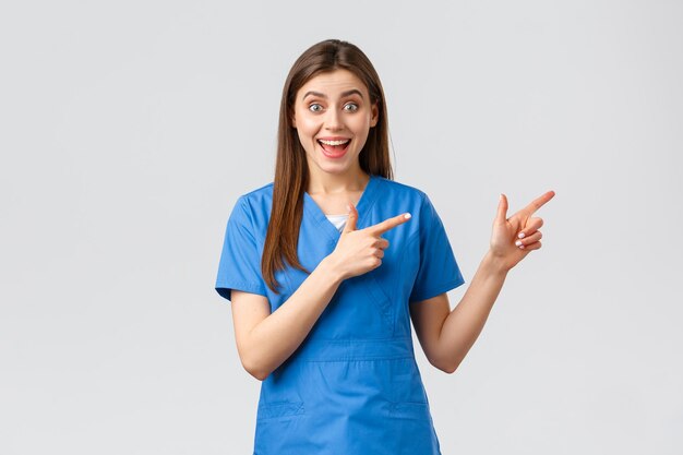 Portrait of smiling young woman standing against white background