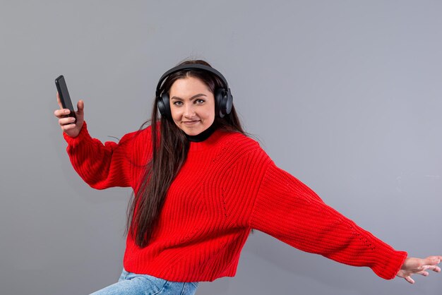 Portrait of smiling young woman standing against white background