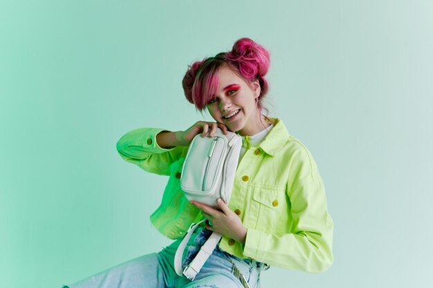 Portrait of smiling young woman standing against white background