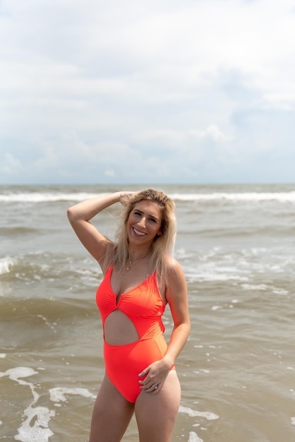 Portrait of smiling young woman standing at beach