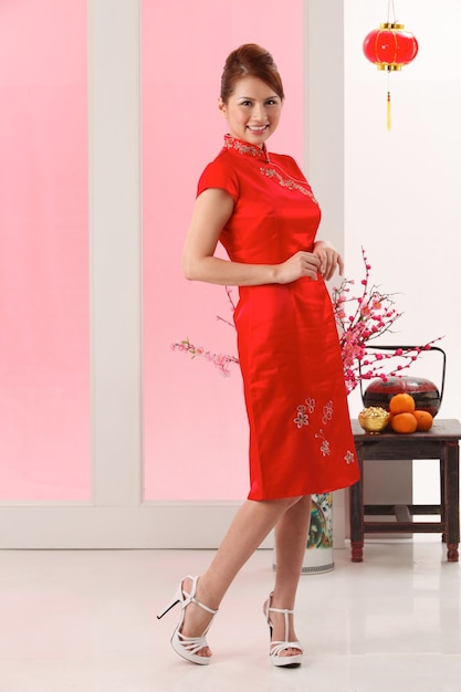 Portrait of smiling young woman standing on floor