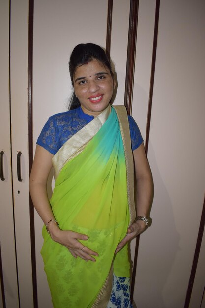 Portrait of smiling young woman standing at home