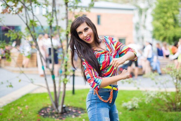 Portrait of smiling young woman standing outdoors