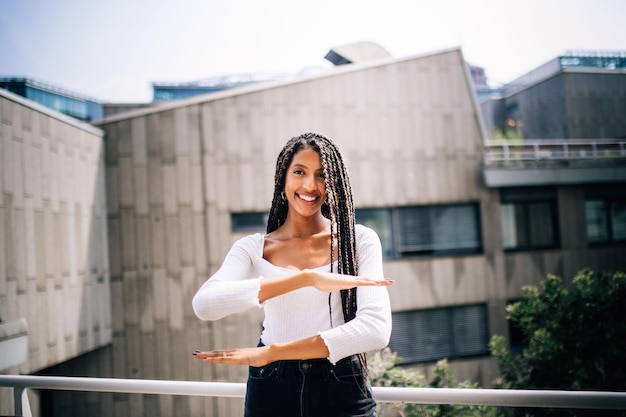 portrait of a smiling young woman standing outdoors