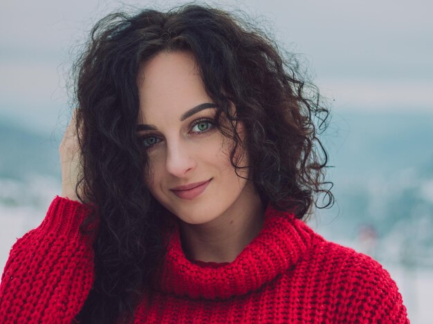 Portrait of smiling young woman standing outdoors