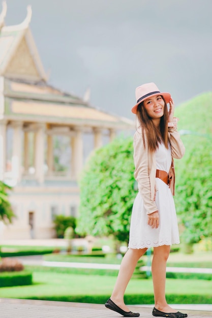 Portrait of smiling young woman standing at park