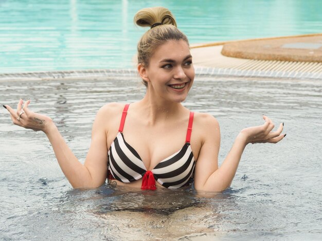 Portrait of smiling young woman in swimming pool