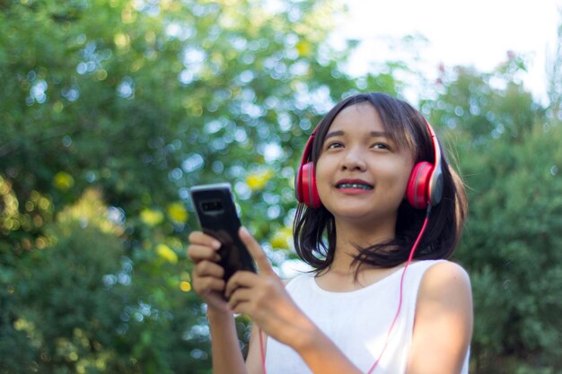 Portrait of smiling young woman using mobile phone