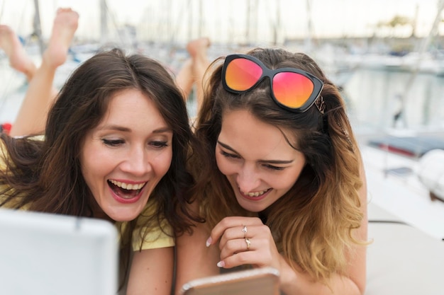 Portrait of smiling young woman using mobile phone