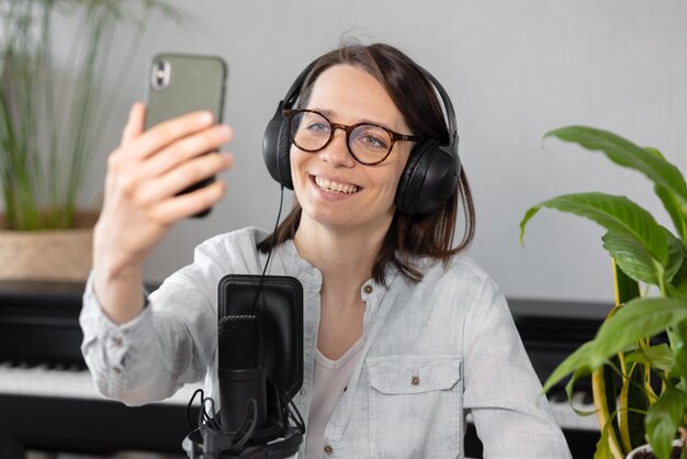 Portrait of smiling young woman using mobile phone