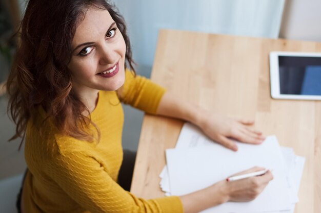 Portrait of a smiling young woman using smart phone