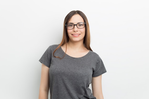 Portrait of a smiling young woman wearing glasses.