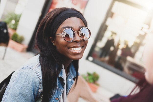 portrait of smiling young woman wearing sunglasses
