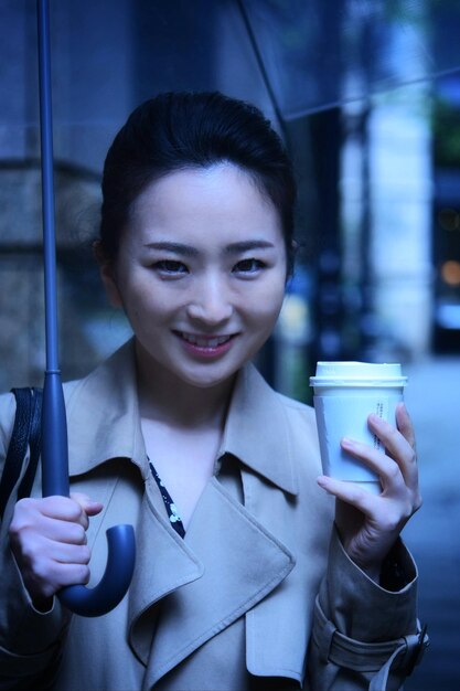 Portrait of a smiling young woman with coffee