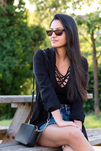 Portrait of smiling young woman with dark clothing