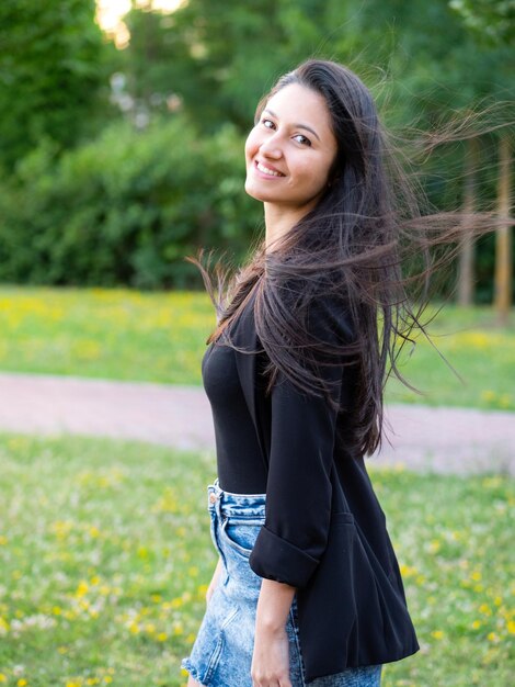 Portrait of smiling young woman with dark clothing