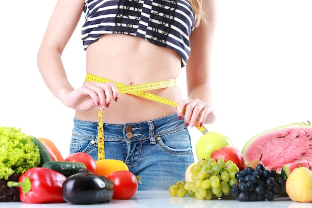 Portrait of a smiling young woman with fresh vegetables isolate