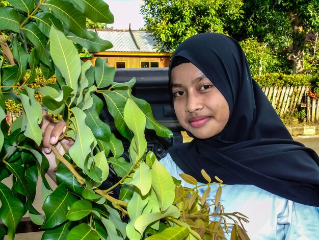 Portrait of smiling young woman with plants