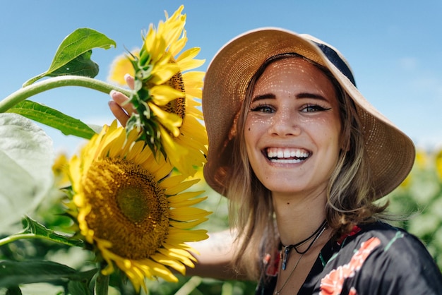 Portrait of smiling young woman with sunflowers