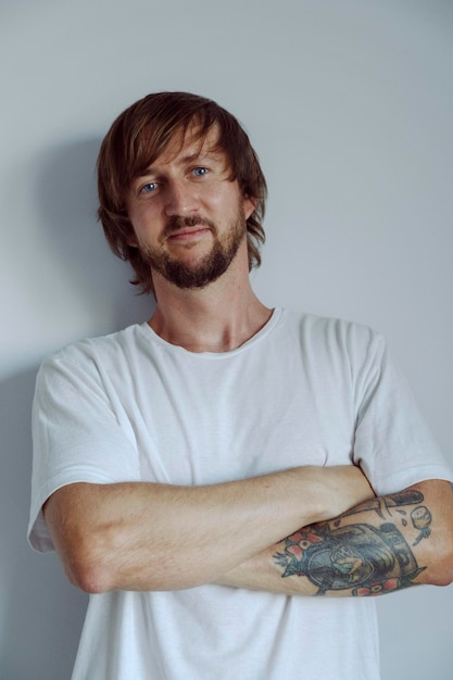 Portrait of smily man with a beard in white t shirt High quality photo