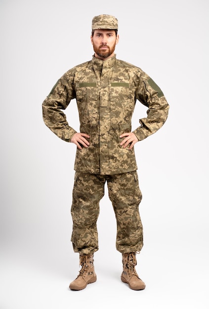 Portrait soldier wearing camouflage military uniform looking at camera isolated on white background