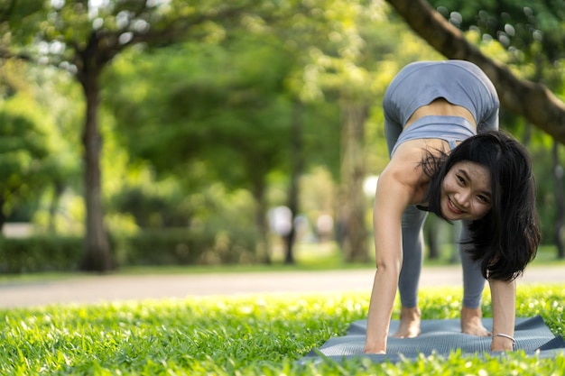 Portrait sport asian beauty body slim woman in sportswear sitting relax and girl practicing yoga and do fitness exercise in park at homeDiet conceptFitness and healthy