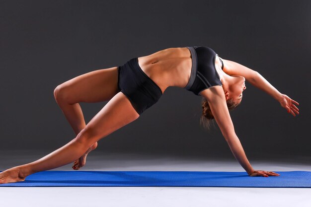 Portrait of sport girl doing yoga stretching exercise