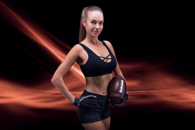 Portrait of a sportive girl in the uniform of an American football team player. Sports concept. Futuristic background. Mixed media