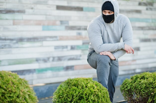 Portrait sports arabian man in black medical face mask and hoodie during coronavirus quarantine.