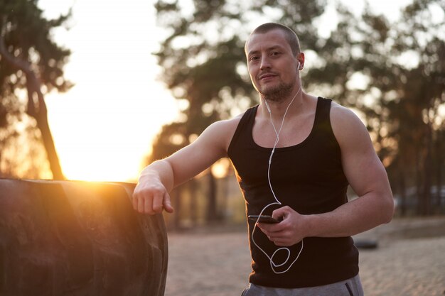 Portrait of a sporty man listening to music