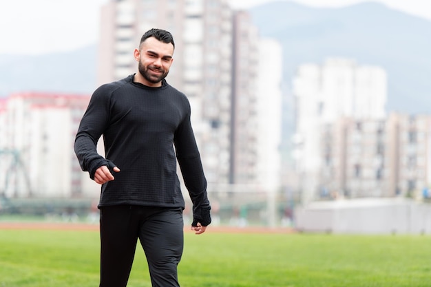 Portrait of sporty man on running track