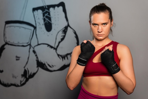 Photo portrait of a sporty woman who is preparing for boxing training