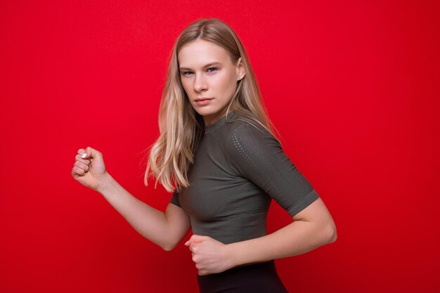 Portrait of a sporty young woman on a red background