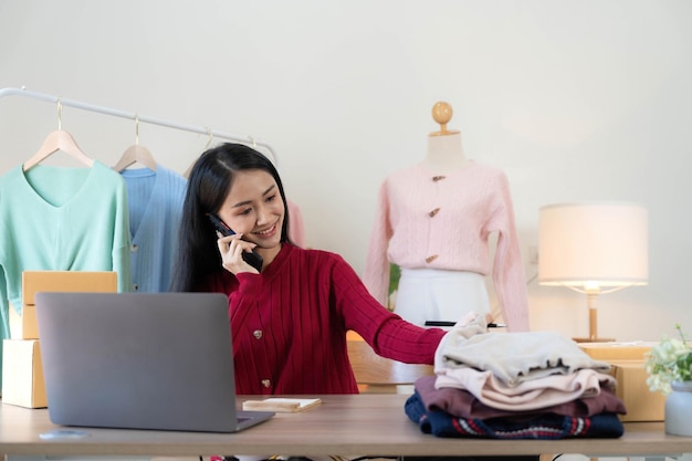 Portrait of starting small businesses sme owners asian woman\
check online orders selling products working with boxs freelance\
work at home office sme business online small medium\
enterprise