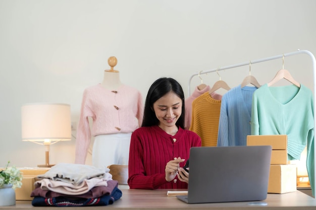 Portrait of starting small businesses sme owners asian woman\
check online orders selling products working with boxs freelance\
work at home office sme business online small medium\
enterprise