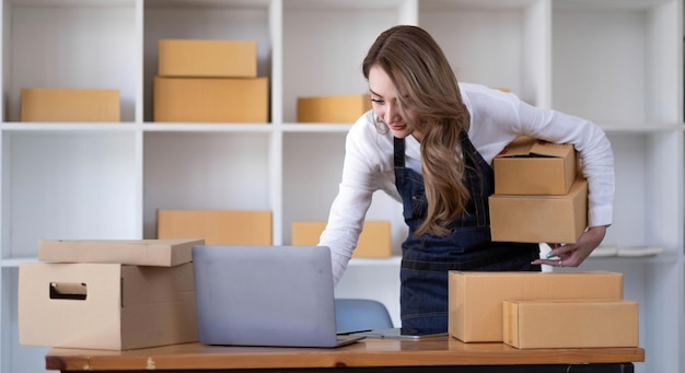 Portrait of Starting small businesses SME owners female entrepreneurs working on receipt box and check online orders to prepare to pack the boxes sell to customers SME business ideas online