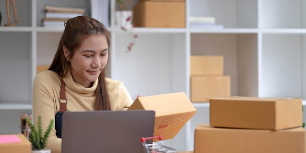 Portrait of starting small businesses sme owners female\
entrepreneurs working on receipt box and check online orders to\
prepare to pack the boxes sell to customers sme business ideas\
online