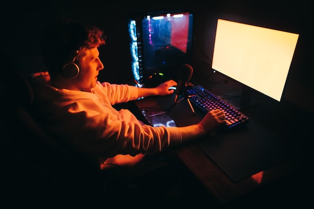 Portrait of a streamer guy shooting video games on computer Gaming concept