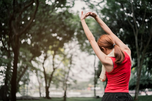 portrait strength woman stretching bicep muscle.